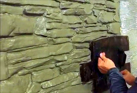 Applying Pro Grade Polyurethane Stone Texture Stamp Set For Concrete Realistic Granite Chipped Look Molds on a wall