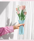 Disposable OPP Flower Sleeve Bags for Bouquets 150 Pack Clear Floral Packaging Wrap holding tulips in blue paper