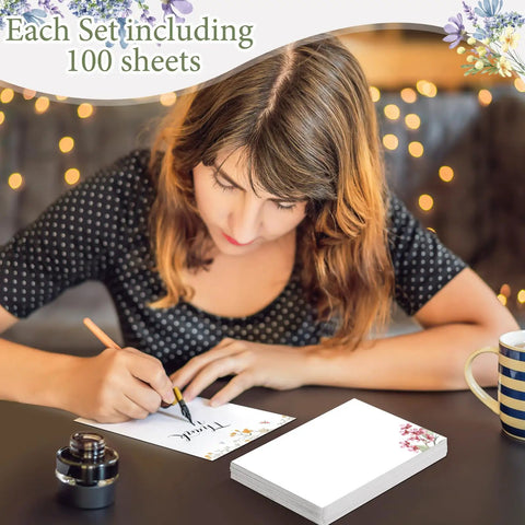 Person writing on 100 Piece Floral Blank Note Cards Set, 4 by 6 Inches, Bulk Notecards for DIY Projects with floral design