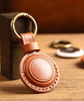 Straight Up Genuine Leather AirTag Keychain Holder Secure Metal Loop Cover Fits Apple Tracker First And Second Gen Like A Glove In Classic Brown Premium Hide Case on wooden surface.