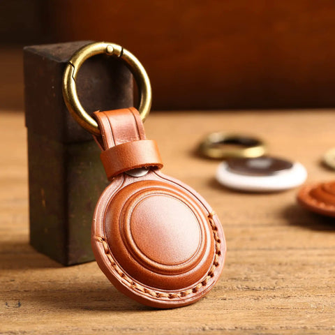 Straight Up Genuine Leather AirTag Keychain Holder Secure Metal Loop Cover Fits Apple Tracker First And Second Gen Like A Glove In Classic Brown Premium Hide Case on wooden surface.