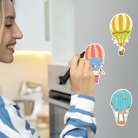 Woman in kitchen using Colorful Hot Air Balloon Sticky Notes Pack Of 12 Styles With 50 Sheets Each Mini Notebooks for reminders.
