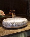 Slick Oval Ceramic Bathroom Sink For Countertop Vanity Rock Solid Above Counter Style With Pop Up Drain No Overflow Easy Setup Knockout Look For Small Half Baths And Daily Home Refreshers, white with gold detailing, on marble countertop.