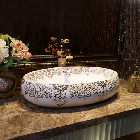 Slick Oval Ceramic Bathroom Sink For Countertop Vanity Rock Solid Above Counter Style With Pop Up Drain No Overflow Easy Setup Knockout Look For Small Half Baths And Daily Home Refreshers, white with gold detailing, on marble countertop.