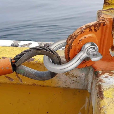 Beefy 3/8 Inch 304 Stainless Steel D Ring Shackles With Screw Pin Anchor Design Rock Solid Rigging Hardware For Traction Wire And Off Road Builds Top Shelf Quality 2 Pack secured to a boat with orange connection.