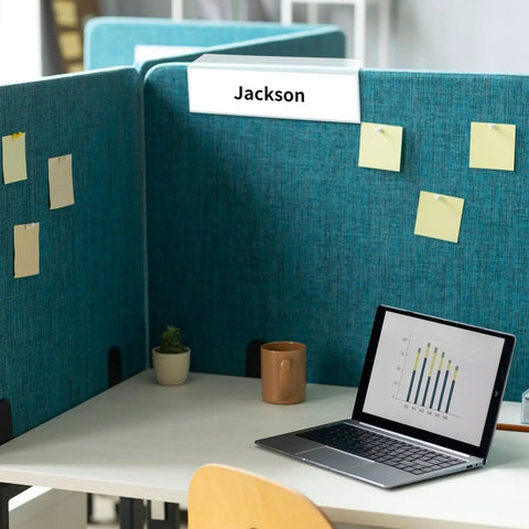 Set Of 10 Clear Cubicle Name Plate Holders For 2.25 Inch Wall Cubicle Signs displayed on blue fabric cubicle with a name insert.