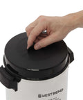 Person opening a 42-Cup Coffee Urn With Automatic Temperature Control, Quick One Cup Per Minute Brew, silver exterior visible