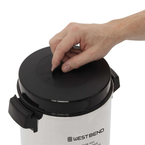 Person opening a 42-Cup Coffee Urn With Automatic Temperature Control, Quick One Cup Per Minute Brew, silver exterior visible