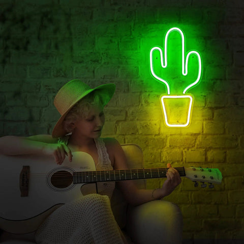 Yellow And Green Cactus Neon Light For Bedroom USB Powered LED Sign With Switch Fun Bright Wall Decor For Dorm Gaming Room Or Living Space 18.5 By 10 Inches illuminating wall near person with guitar