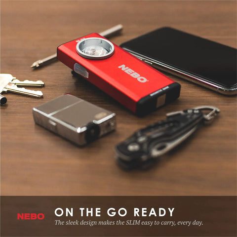 Slim 6694 Red Rechargeable Flashlight Delivers 500 Lumens Of Bright COB LED Power with phone, keys, lighter on table.
