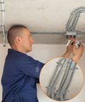 Electrician using heavy duty PVC conduit clamps 2 hole U clip straps for half inch cables and pipes on ceiling installation.