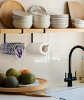 Absolute Knockout Tumbler Lid Organizer That Snaps Right Onto Standard Cups And Keeps Your Counter Dead Clean Without Any Hassle While Holding Ten Sip Lids In Chill Modern Black Design mounted under kitchen shelf.