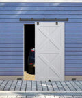 Heavy Duty Exterior Barn Door Hardware Kit 6 Ft Wall Mounted Slide Track Black finish on a rustic garage door.