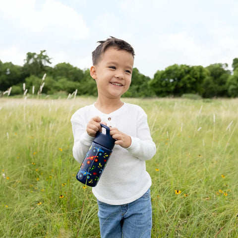 Keep Things Chill In Backpacks With This Kid Approved Confetti Insulated Water Bottle Packed With A Leak Proof Straw Lid And Double Wall Stainless Steel Build For Little Ones 14 Oz. held by smiling child outdoors.