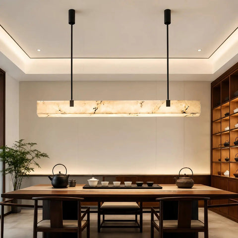Artpad 47.24-Inch Modern Long Marble Dining Pendant Light, Suspension Lamp above a dining table with a black kettle.