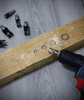 Drill with 8 Piece Wood Plug Cutter Drill Bit Set With Pro Grade Titanium Coated Carbon Steel Bits on wooden board
