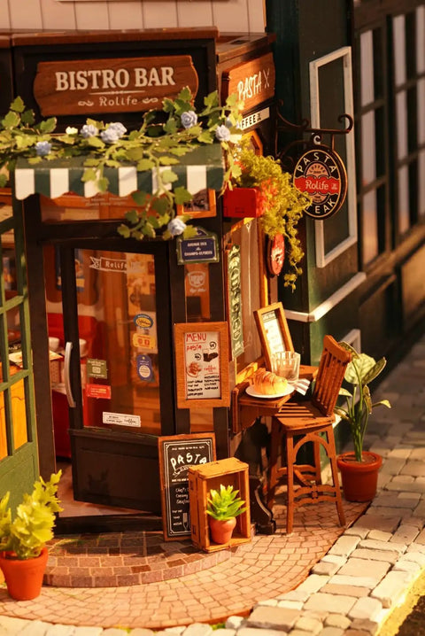 Front view of Charming Bistro Style Miniature House Kit With LED, featuring cozy cafe decor and plants, 9.37x7.09x7.17 inches