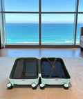 20 Inch Carry On Luggage With Usb Charging Port And Cup Holder Abs Hardshell Suitcase open with clothing inside, smooth rolling wheels, ocean view.
