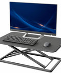 Budget Friendly 29 Inch Height Adjustable Standing Desk Converter For Sit Stand Workstation Monitor And Laptop Riser Platform Easy Elevation Durable Steel Frame Compact Desk Accessory For Home Office showing a computer setup