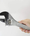 Hand holding a 15 Inch Adjustable Wrench With 45mm Jaw Opening For Heavy Duty Garage And DIY Projects, Beefy Drop Forged Chrome Vanadium Steel.