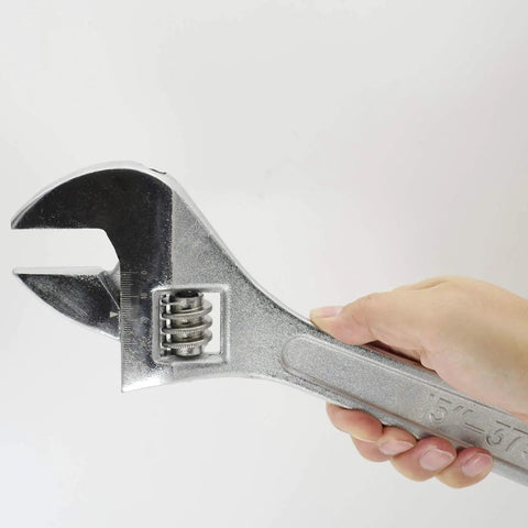 Hand holding a 15 Inch Adjustable Wrench With 45mm Jaw Opening For Heavy Duty Garage And DIY Projects, Beefy Drop Forged Chrome Vanadium Steel.