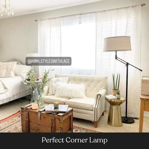 Mid Century Modern Dope Height Adjustable LED Floor Lamp in a cozy living room corner next to a beige sofa and potted plants.