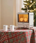 13Quart Sublimation Oven Cranks Out Vivid Transfers Fast With 360 Degree Surround Heat Designed For 20Oz Tumblers And Stainless Steel Flasks ready on a table with two white mugs.