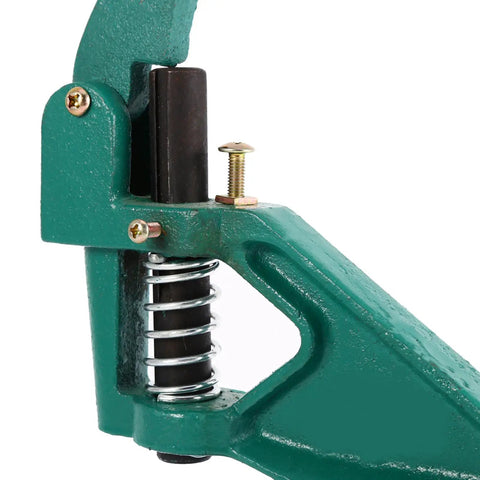 Close-up of Grommet Eyelet Hand Press Tool With Interchangeable Dies, showing spring mechanism and metal components.