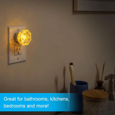 SleepLite Jewel Amber Led Night Light Plug In Always On Energy Efficient UL Certified 2 Pack illuminating a bathroom wall