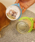 Universal Silicone Can Lids For Dog And Cat Food, 3 Pack With Spoon, multi-colored lids on cans, cat lying nearby