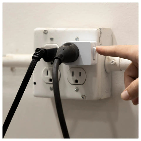 Person pressing On Off button on Grounded Power Switch 2 Pack Outlet Extender With On Off Button, 3 Prong Indoor Lights And Small Appliance Adapter, Easy Install, Energy Efficient, Space Saving Design, UL Listed, White, 39713.