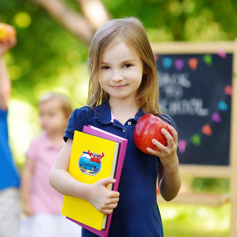 Child holding book with 160 Ocean Animals Name Tag Stickers Set With Eight Cute Sea Creature Designs For Back To School