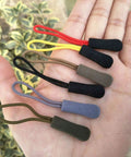 20 Pack Easy Grip Zipper Pulls With Cord For Backpacks And Jackets Non Slip Rubber Tab Replacement Slider Repair Kit For Bags, Tents, Clothes DIY Accessory Fix Red displayed in hand.