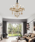 6 Light Crystal Chandelier With Metal Frame And Six Arms Vintage Candle Style Pendant Ceiling Light Cognac Finish With Raindrop Crystals Dimmable Bulbs Compatible 23 Inch Diameter 22 Inch Height Adjustable Chain Up To 47 Inches in a living room setting.