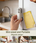 Person placing Rechargeable 2 In 1 Bag Sealer With Cutter And Magnet on fridge, highlighting portable magnetic design.
