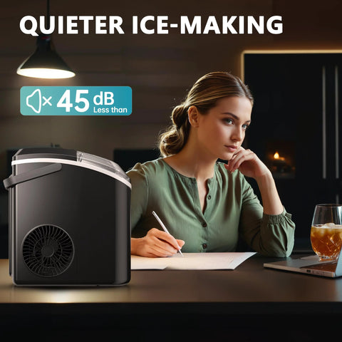 Nugget ice maker on countertop with handle; black portable appliance beside a person writing.