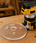 Six Inch Clear Acrylic Router Base Plate With Precision Pre Drilled Holes For DWP611 And DCW600B Compact Routers next to a router.