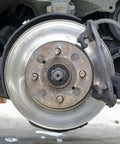 Car brake disc with visible studs and caliper, illustrating use for 340 Piece Black Internal Tooth Lock Washers And Push On Clips Fasteners Kit