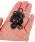 Hand holding black washers from 100 Pcs Skateboard Bearing Washers And Hardware Kit For Trucks And Longboards, Speed Washers, Spacers, Nuts And Bolts
