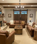 Cozy living room featuring leather sofas, wood coffee table, and rustic decor, showcasing Straight Up Premium Aging Wood Stain In Ranchworn.