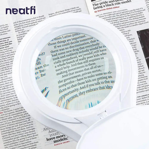 LED Magnifying Lamp With Clamp, 1,200 Lumens, 5-Inch Glass Lens, close-up view magnifying text on a page