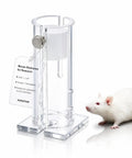 Acrylic Mouse Restrainer With Adjustable Sliding Plugs For Keeping 15 To 35 Gram Rodents Locked In During Procedures With No Fuss and Rock Solid Lab Setup next to a white lab mouse.