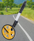 Measuring Wheel 0-9999.9m Digital Display for Construction Worker, lightweight ABS and metal construction with a yellow rolling wheel.