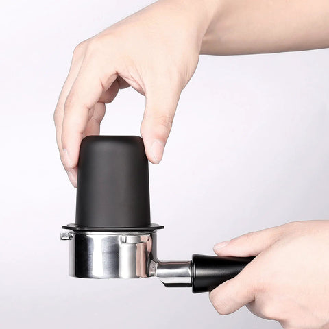 Hand placing 53.3mm Portafilter Dosing Cup in 304 Stainless Steel with Matte Black Nonstick Finish onto Breville portafilter.