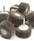 Aluminum Oxide Flap Wheel Set Two Inch By One Inch With Quarter Inch Shank Mounted 80 Grit in a pile, side view.