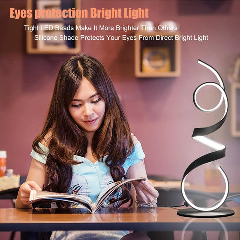 20W Remote Control Dimmable LED Art Table Lamp beside woman reading, modern abstract design, black finish