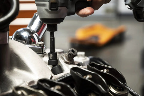 12 Piece 1 Quarter Inch Drive 6 Point Universal Impact Socket Set Metric in use on engine with black phosphate finish