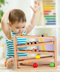 Child playing with Wooden Race Track Ramp Toy For Toddlers 5 Level Car Ramp Set With 4 Wood Cars And 3 Balls No Assembly