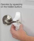 Hand activating OutSmart Lever Handle Lock 4 Pack White Kid Safe Kidproof Lock For Lever Handles With Hidden Buttons And Decoy Button.