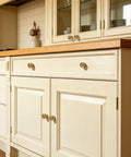 Durable Zinc Alloy Vintage Cabinet Knobs Five Pack - Antique Brass Drawer Pulls Art Deco Star Detail on cream kitchen cabinetry.